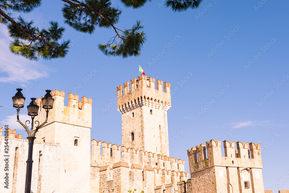Castle in the north of Italy near the lake. Ancient castle and blue sky. Travel in Europe and tourism. Free space for text.