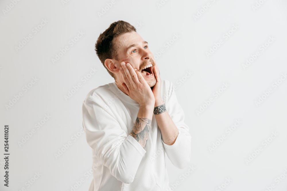Happy business man standing, smiling isolated on gray studio background. Beautiful male half-length portrait. Young satisfy man. Human emotions, facial expression concept. Happy business man standing, smiling isolated on gray studio background. Beautiful male half-length portrait. Young satisfy man. Human emotions, facial expression concept.