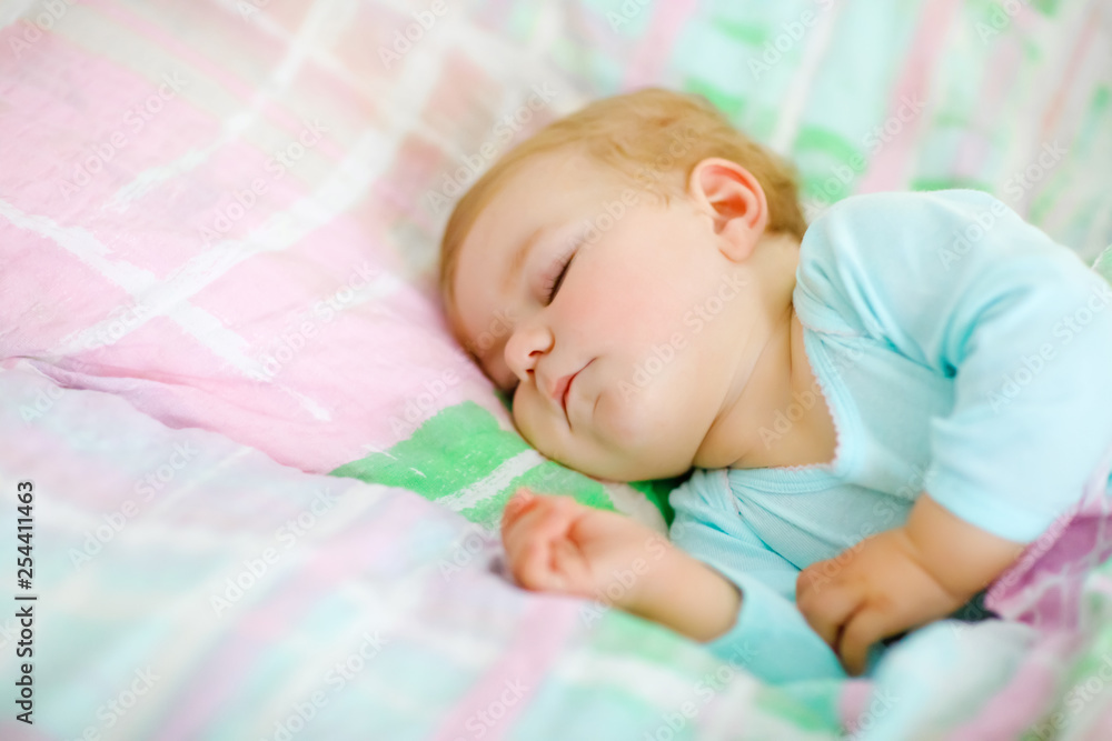 Adorable little baby girl sleeping in bed. Calm peaceful child dreaming during day sleep. Beautiful baby in parents bed. Sleeping together concept. Adorable little baby girl sleeping in bed. Calm peaceful child dreaming during day sleep. Beautiful baby in parents bed. Sleeping together concept.