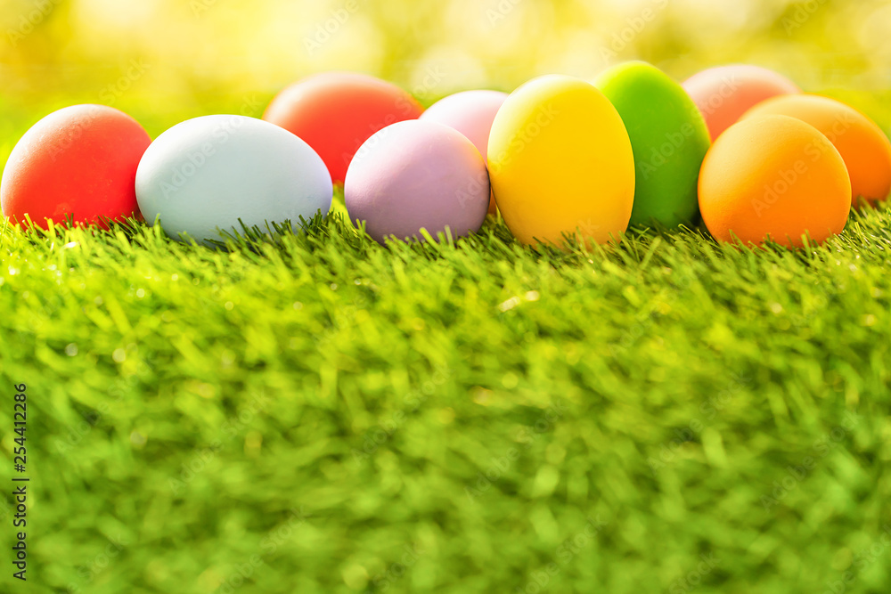 Colorful Easter eggs on green grass