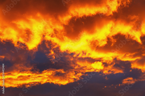 colorful sunset with golden clouds at the end of the summer day
