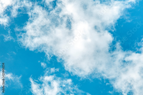 Teal blue sky with white clouds, an abstract background with copy space