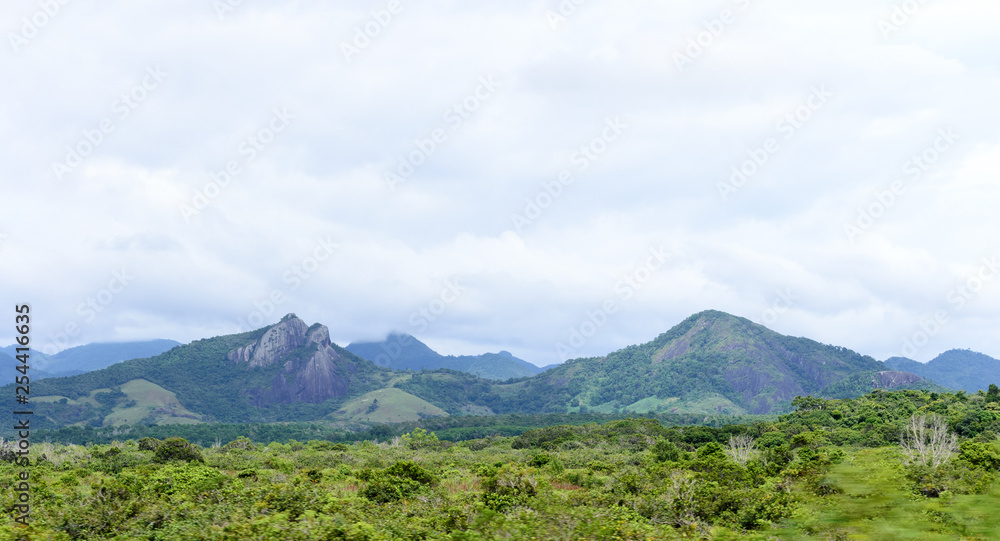 Brazilian landscape, road trip in the Espirito Santo state. Wide valleys, nice greenery of atlantic forest and mountains in the background