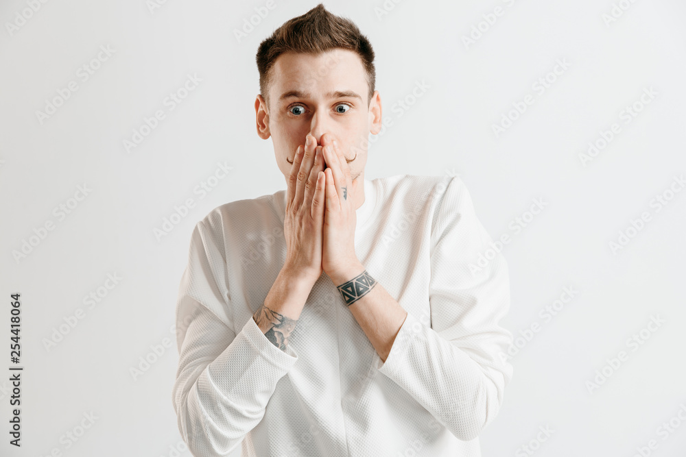 Why is that. Beautiful male half-length portrait isolated on gray studio backgroud. Young emotional surprised, frustrated and bewildered man. Human emotions, facial expression concept. Why is that. Beautiful male half-length portrait isolated on gray studio backgroud. Young emotional surprised, frustrated and bewildered man. Human emotions, facial expression concept.