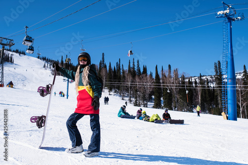 Woman snowboarder on a snowy slope.