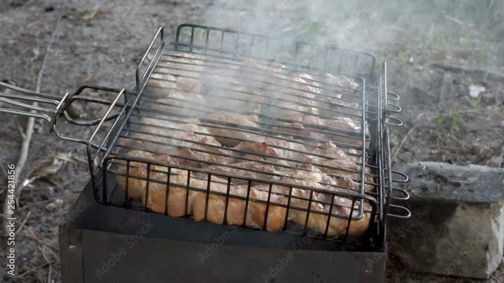 Barbecue delicious grilled meat. The meat is fried on the grill in the open air. Close up. The view from the top. 4k. 25 fps. Barbecue delicious grilled meat. The meat is fried on the grill in the open air. Close up. The view from the top. 4k. 25 fps.