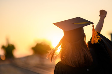 Graduates wear a black dress, black hat at the university level.