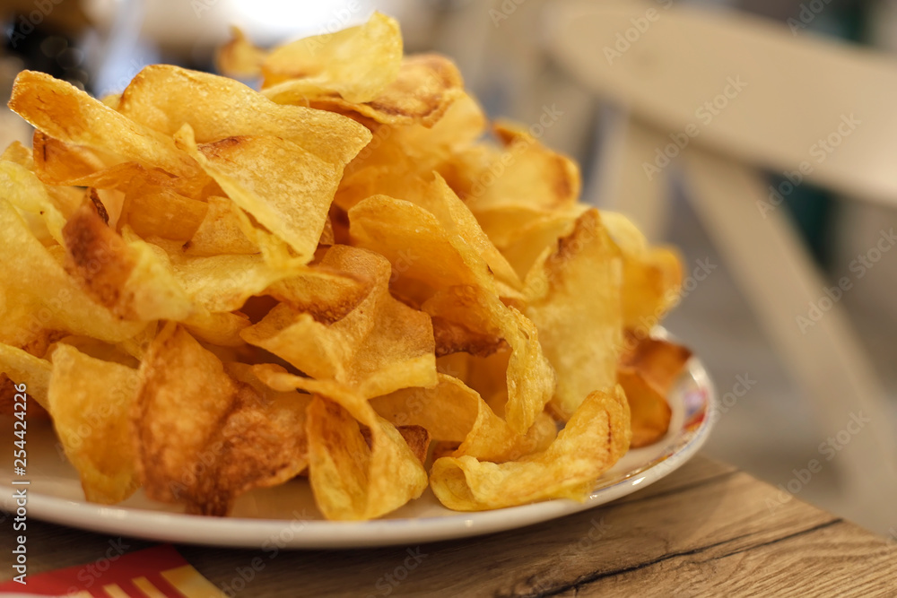 Many golden potatoes fried on the plate in a restaurant, french fries Many golden potatoes fried on the plate in a restaurant, french fries