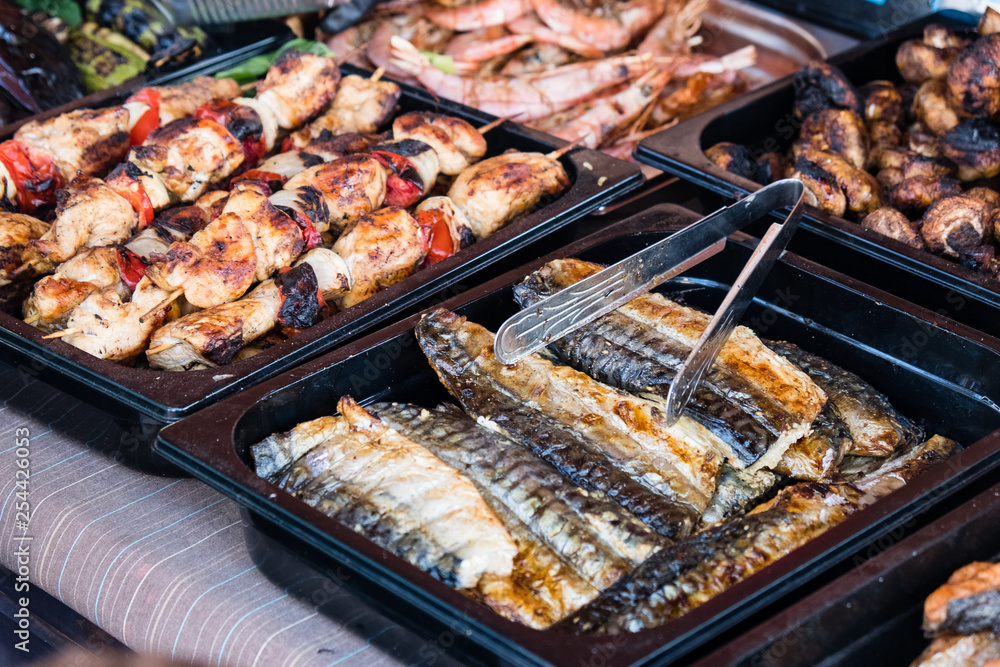 Outdoor Cuisine Culinary Buffet with healthy take away meal - grilled vegetables, fish and meat on the street food culinary market, festival, event.