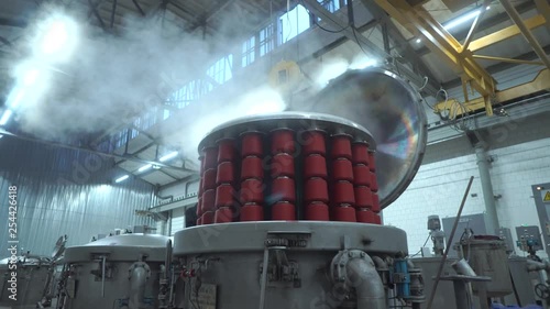 Textile factory female worker works with thread coloring machine. Modern technology in dyeing yarns with Machines for Textile Industry, Dyeing Machine Chemical Tanks