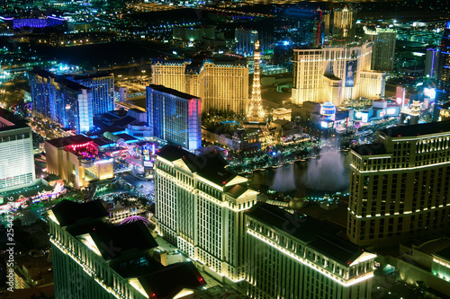Casinos of Las Vegas with night show, aerial view  at night from helicopter