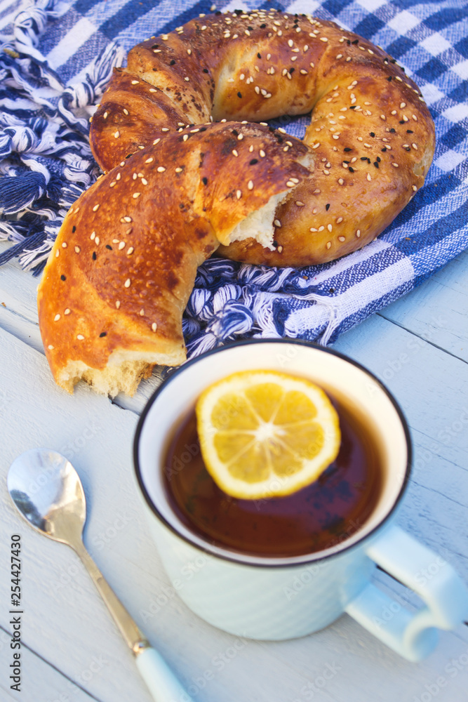 Turkish bagels with tea of cup on wooden blue background. Turkish bagels with tea of cup on wooden blue background.