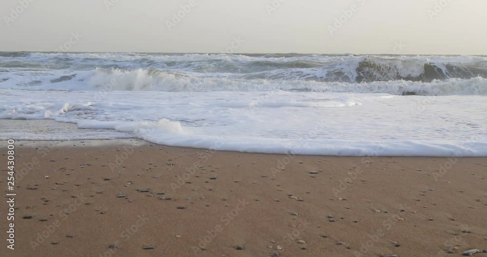 Soft wave of the sea on the sandy beach with white clean foam Soft wave of the sea on the sandy beach with white clean foam