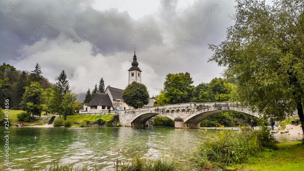 Church and bridge on Bohinj lake in Slovenia near the Triglav mountain adn part of Triglav national pak