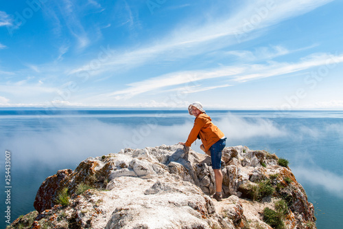 Tourist on the rock of Olkhon island. View of Baikal