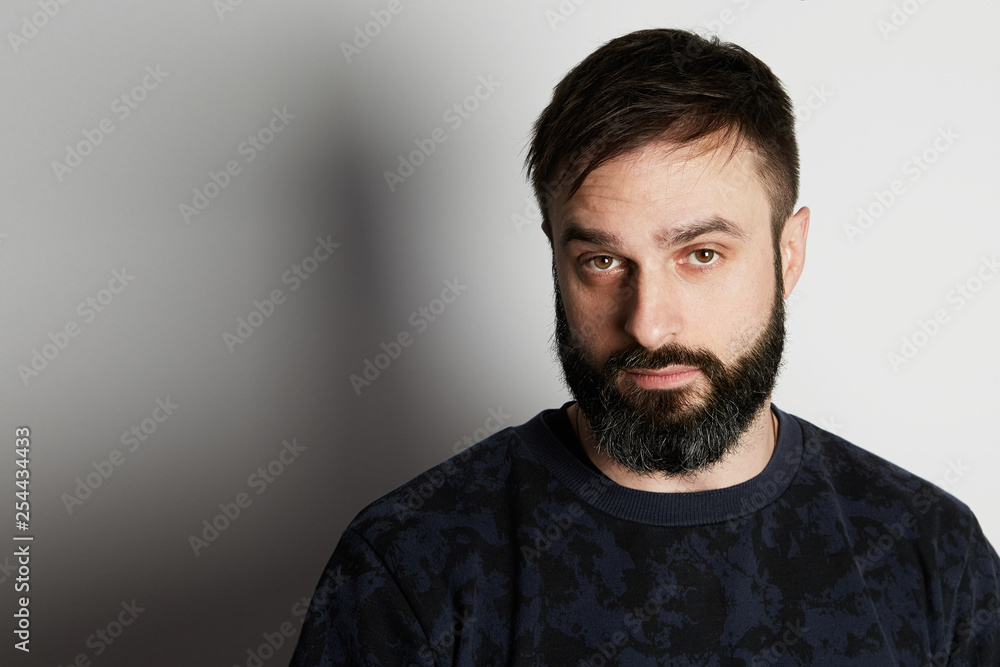 Fototapeta premium Cute bearded young man on white background