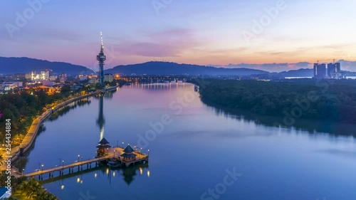 High quality aerial view of Kuantan city time lapse during sunrise with fisherman boats crossing the river. photo