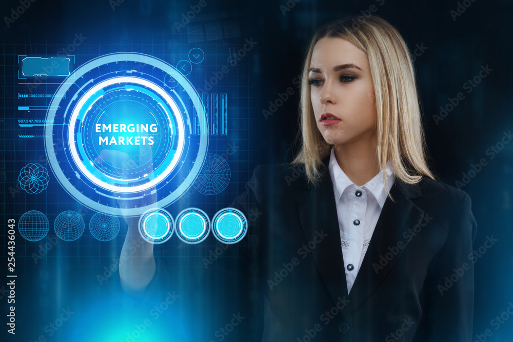 The concept of business, technology, the Internet and the network. A young entrepreneur working on a virtual screen of the future and sees the inscription: Emerging markets The concept of business, technology, the Internet and the network. A young entrepreneur working on a virtual screen of the future and sees the inscription: Emerging markets
