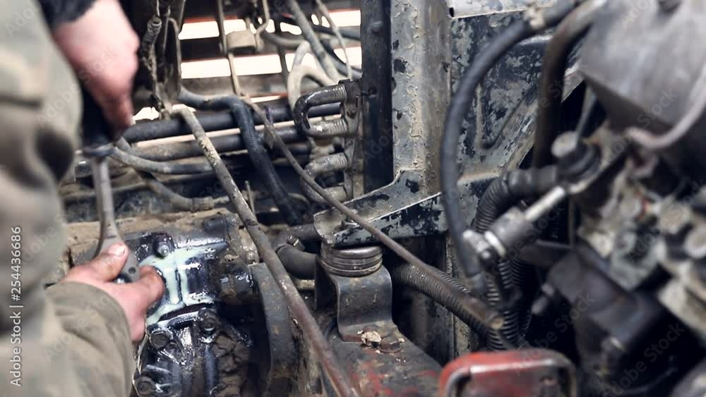 Car repair. Hand mechanic twists the drain oil plug in the car. Car repair. Hand mechanic twists the drain oil plug in the car.
