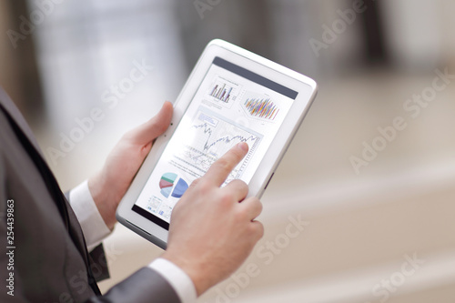 Close up of Man's hands working with digital tablet, Financial