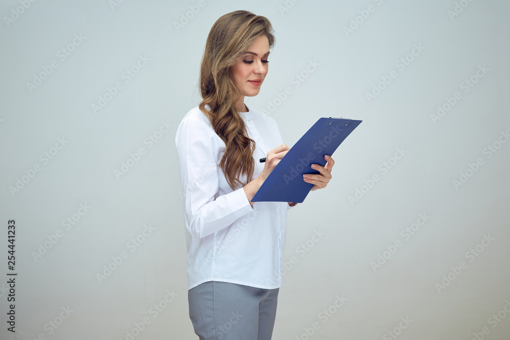woman doctor or nurse writes on blue clipboard. woman doctor or nurse writes on blue clipboard.