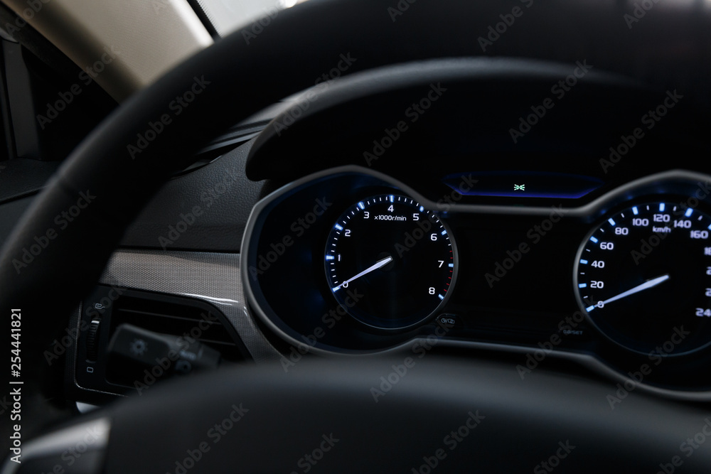 Close-up of a modern dashboard in an expensive car. The steering wheel is blurred. Advanced technology concept