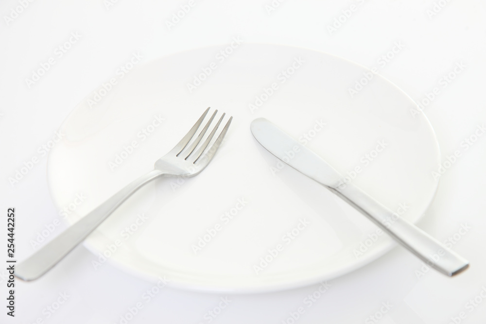white dish on the white table with cutlery meaning PAUSE