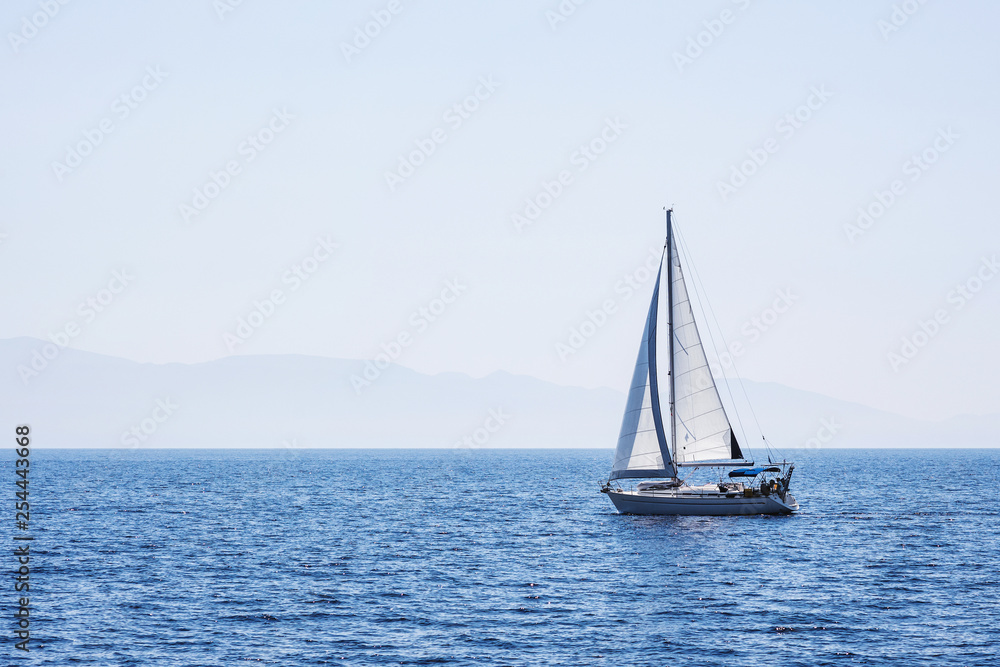 Beautiful bay with sailing boat yacht. Sailboat in a mediterranean sea. Yachting, travel, active lifestyle, summer fun and enjoying life concept