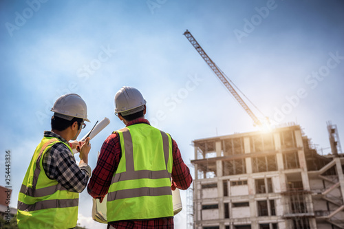 Ταπετσαρία τοιχογραφία Construction engineers discussion with architects at construction site or building site of highrise building with blueprints