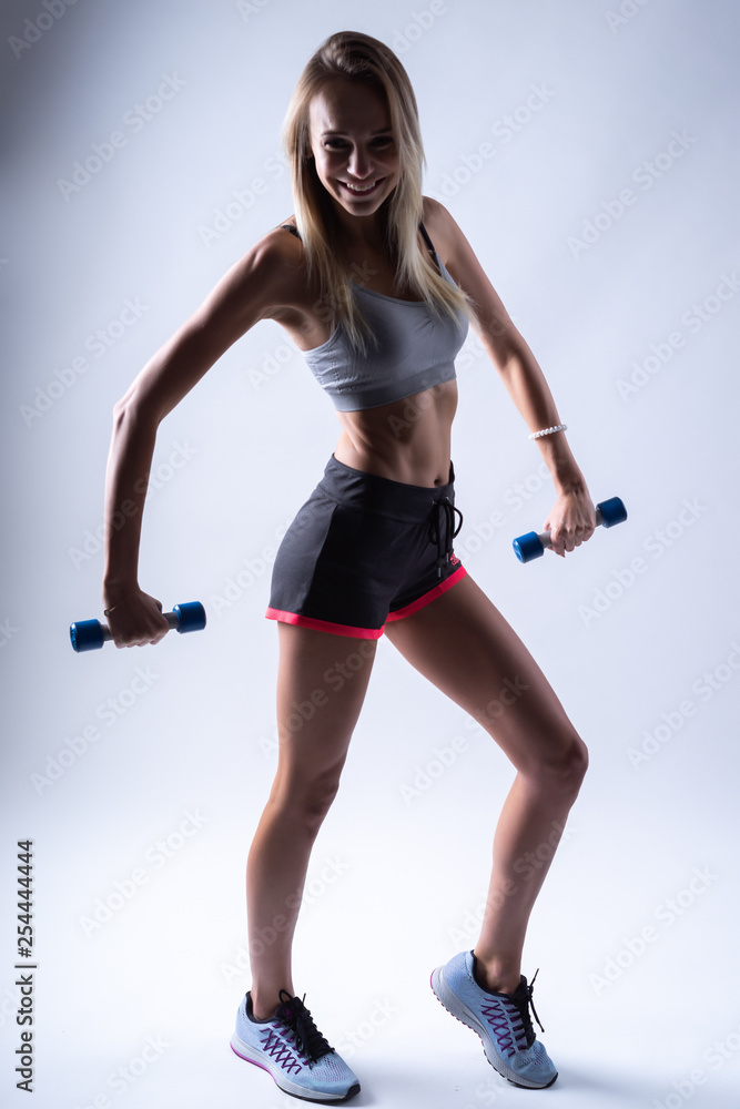 young woman with dumbbell on white background young woman with dumbbell on white background