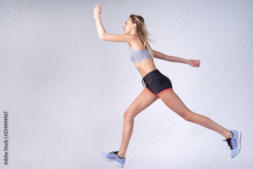 Not a professional girl on white background. Dynamic movement. © dima