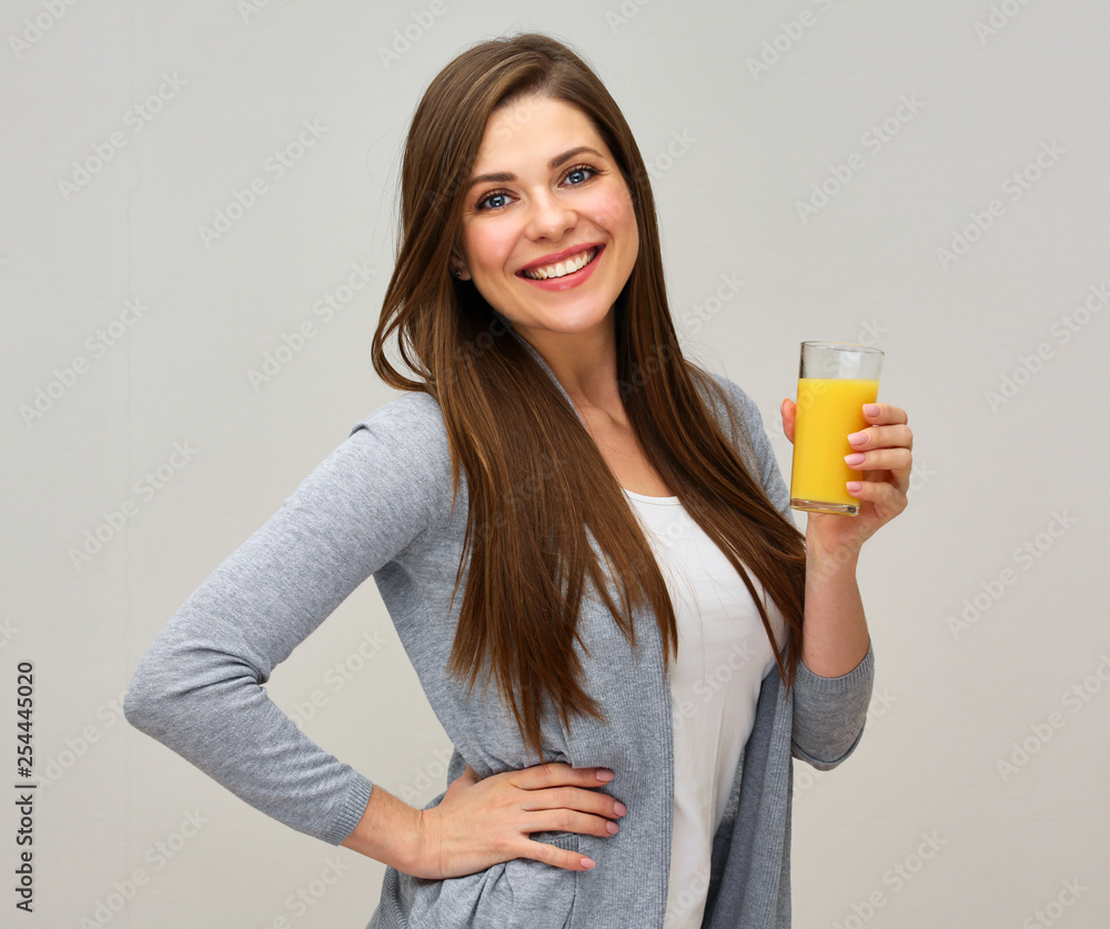 smiling woman wearing casual clothes holding glass with orange juice. smiling woman wearing casual clothes holding glass with orange juice.