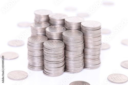 stacked many Japanese 100yen coins on white background photo