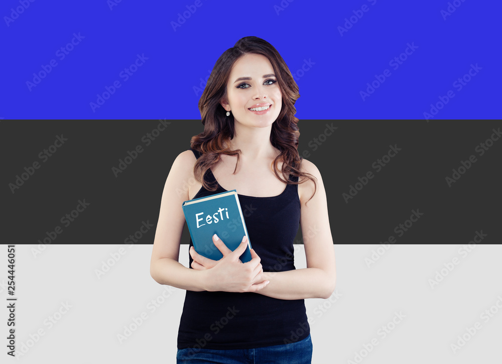 Portrait of beautiful woman student with book against the Estonia flag background. Learn estonian language concept Portrait of beautiful woman student with book against the Estonia flag background. Learn estonian language concept