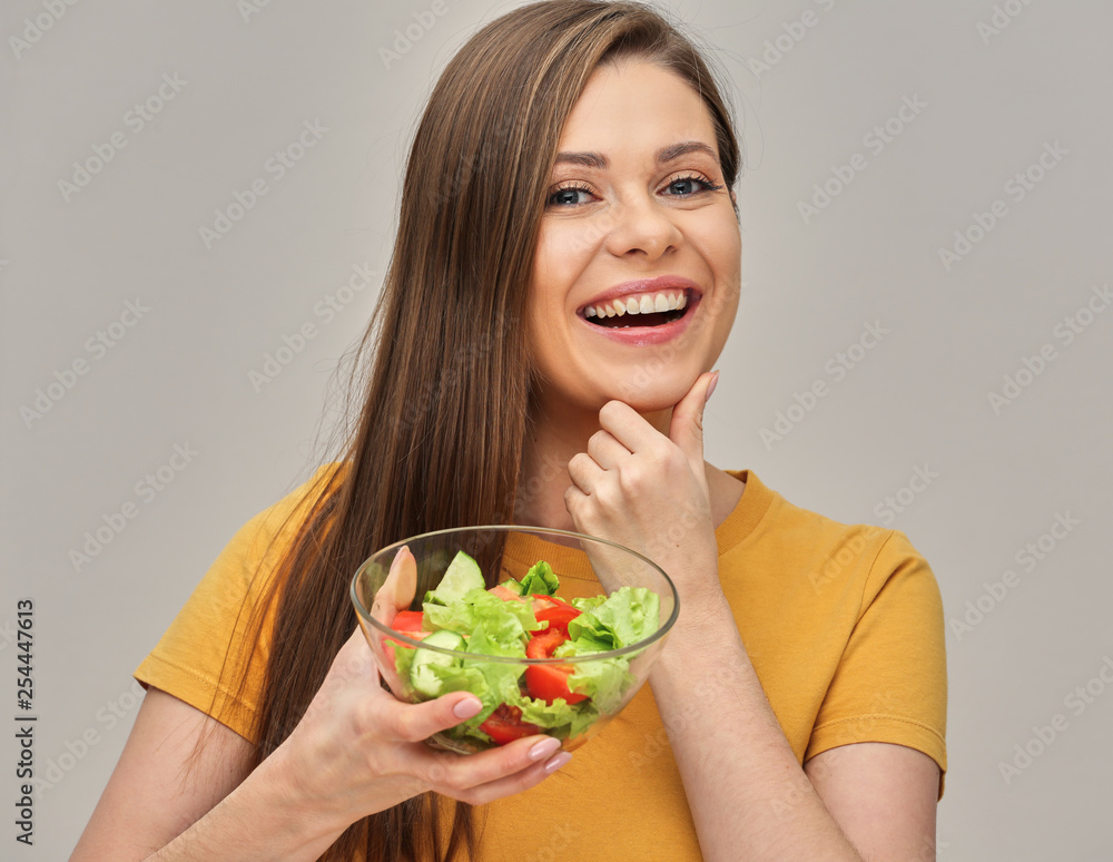 Smiling woman holding salad in glass bowl. Smiling woman holding salad in glass bowl.
