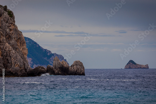 Paleokastritsa bay cliffs with Kolyviri island on a rainy day