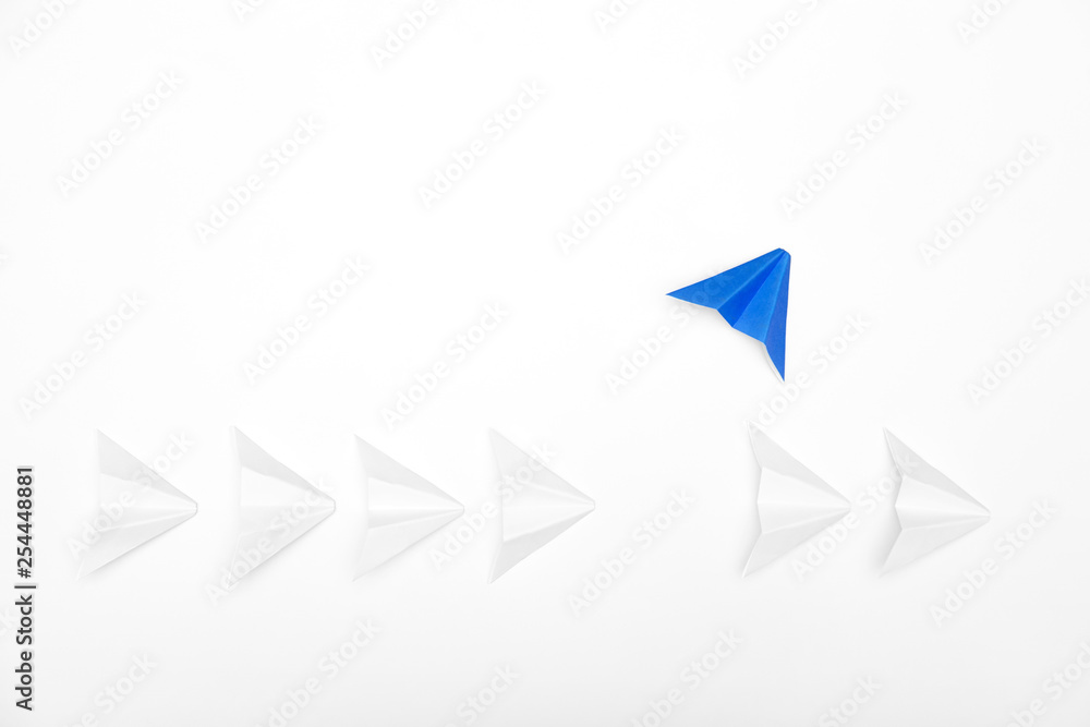 Stand out concept. Red paper airplane standing out from line of white Stand out concept. Red paper airplane standing out from line of white