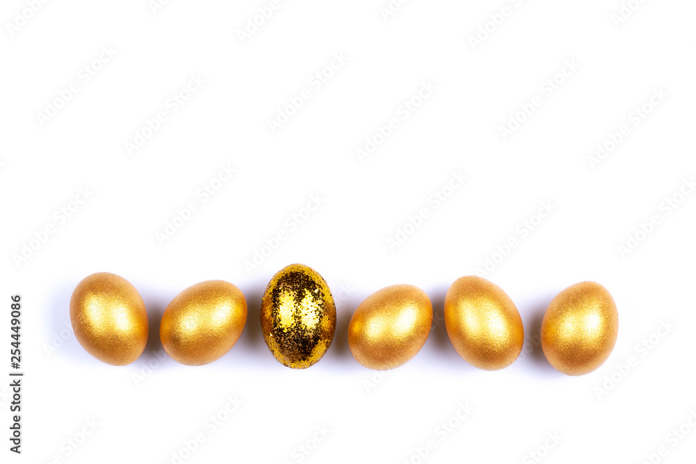 Golden colored Easter eggs isolated on white background. Place for text. Golden colored Easter eggs isolated on white background. Place for text.