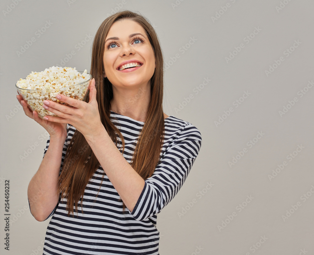happy woman holding glass bowl with popcorn. happy woman holding glass bowl with popcorn.