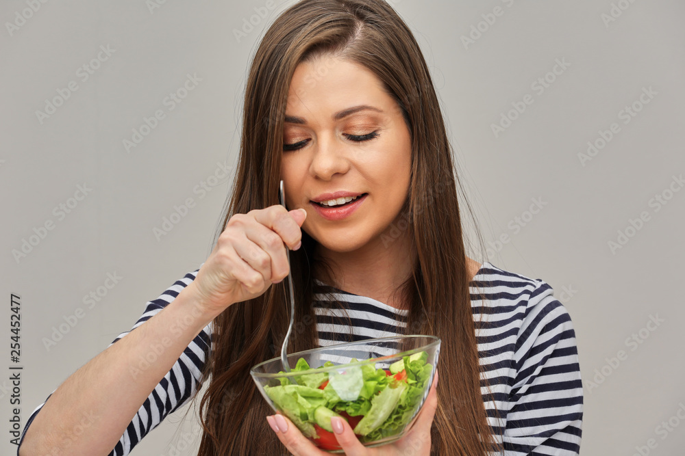 young woman keeps vegetable diet, eating green salad. young woman keeps vegetable diet, eating green salad.