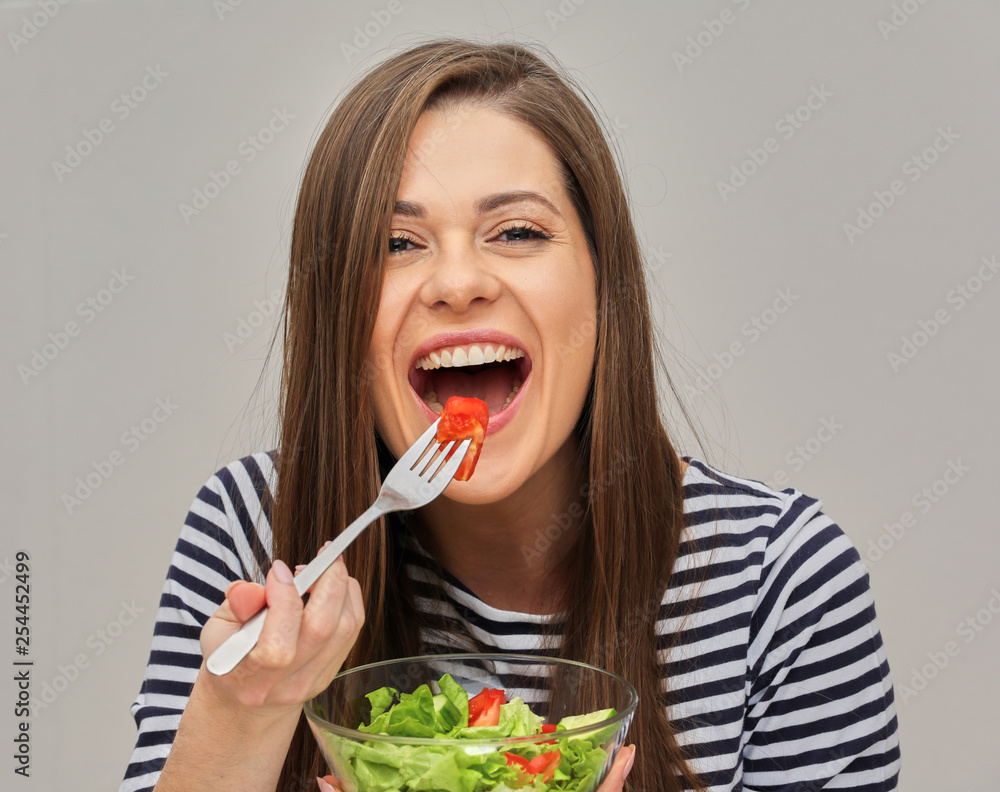 woman eating green salad with tomatoes woman eating green salad with tomatoes