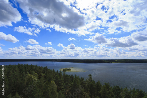 Fototapeta Naklejka Na Ścianę i Meble -  Pine forests surrounding a lake with an island.