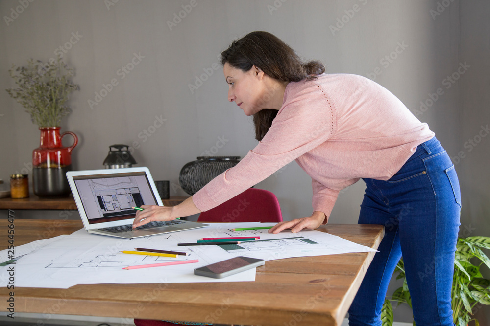 Busy lady elaborating design for flat Busy lady elaborating design for flat