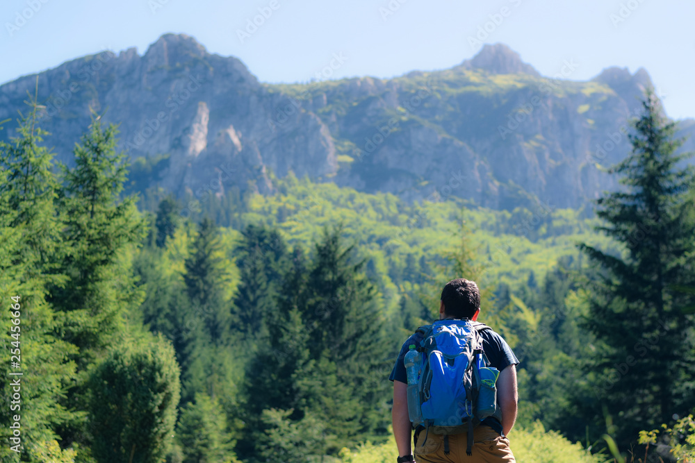 Hiker under the mountains Hiker under the mountains
