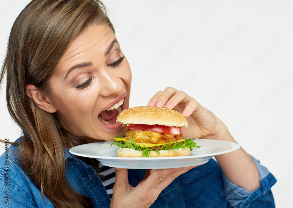 woman eating big burger. Isolated portrait. woman eating big burger. Isolated portrait.