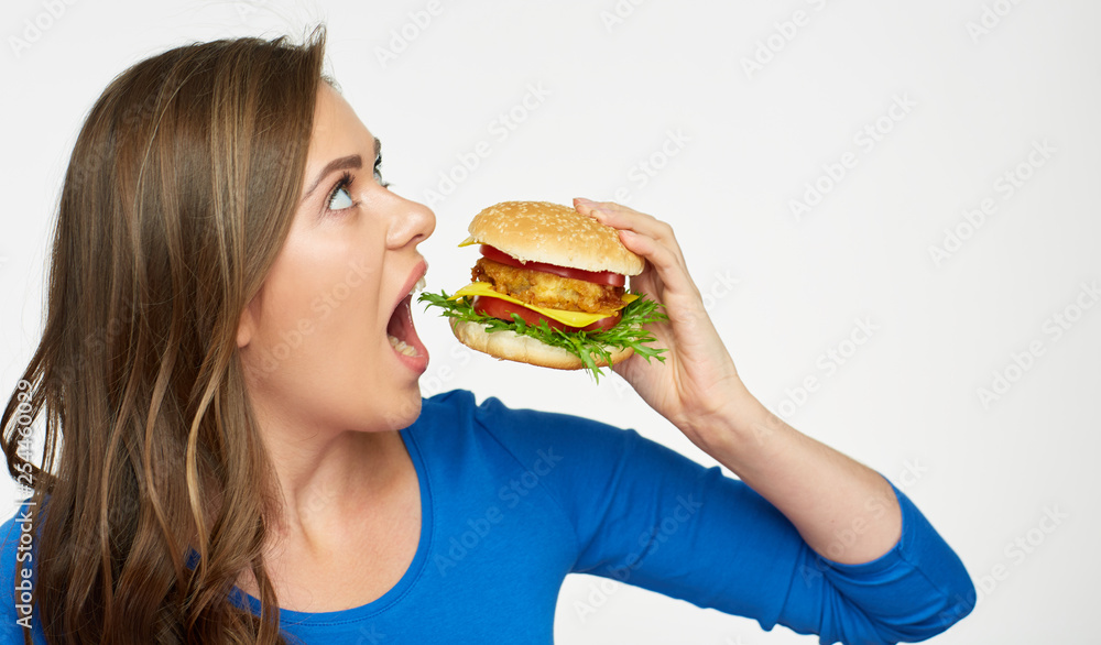 woman eating big burger. Isolated portrait.