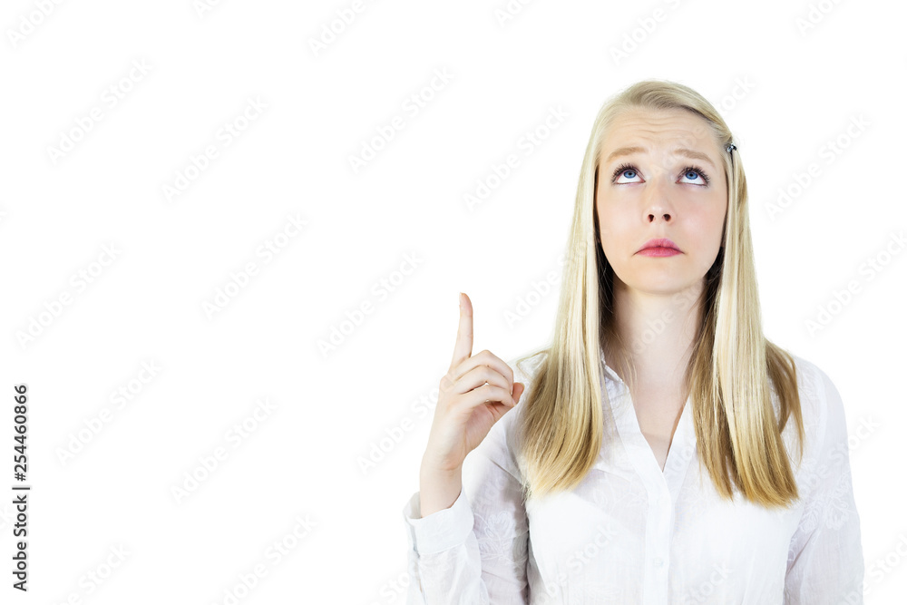 Portrait of young, blonde woman looking up, pointing index finger up.Isolated on white, copy space Portrait of young, blonde woman looking up, pointing index finger up.Isolated on white, copy space