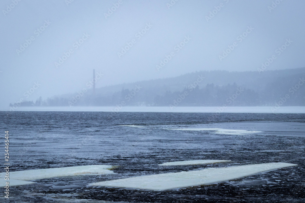 View to hazy hills across a frozen lake