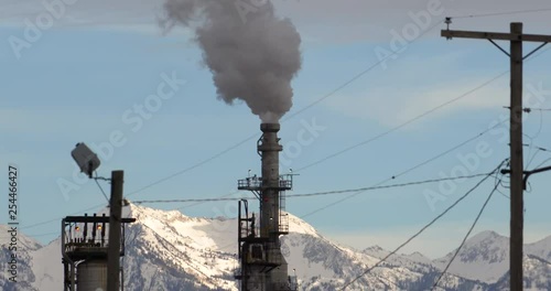 Zoomed in oil refinery steam coming out of tower