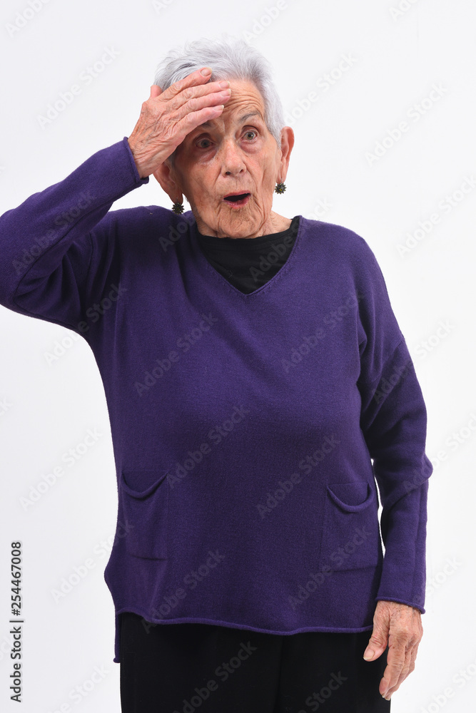 senior woman with expression of forgetfulness or surprise on white background senior woman with expression of forgetfulness or surprise on white background